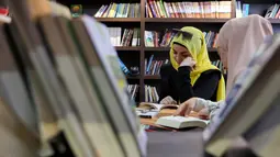Perpustakaan Al-Ankaa atau Phoenix Library yang kembali dibuka pada awal Maret 2026 menjadi simbol kebangkitan warga Palestina di Kota Gaza. Tampak dalam foto, para pengungsi Palestina membaca buku di perpustakaan Al-Ankaa (Phoenix), perpustakaan pertama yang dibuka sejak gencatan senjata di Jalur Gaza yang berisi buku-buku yang diselamatkan dari perpustakaan yang hancur selama perang Israel-Hamas, di lingkungan Rimal, Kota Gaza pada Selasa 21 April 2026. (Omar AL-QATTAA/AFP)