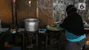 Warga memasak makanan untuk dibagikan di zona merah covid-19 Kelurahan Petogogan RT 006 RW 003, Jakarta, Selasa (22/6/2021). Dapur umum itu menyuplai kebutuhan makanan berat serta minuman untuk warga yang menjalani isolasi dan terdampak akibat COVID-19. (Liputann6.com/Faizal Fanani)