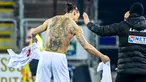 Striker AC Milan, Zlatan Ibrahimovic, menukar jersey saat melawan Cagliari pada laga Liga Italia di Sardegna Arena, Senin (19/1/2021). AC Milan menang dengan skor 2-0. (AFP/Alberto Pizzoli)