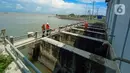 Petugas Dinas Pekerjaan Umum (PU) Kota Semarang memeriksa aliran air di Rumah Pompa Kali Semarang, Jawa Tengah, Kamis (2/1/2020). Dinas PU Kota Semarang melakukan pengerukan sedimentasi dan sampah, persiapan rumah pompa, dan normalisasi saluran air untuk mengantisipasi banjir. (Liputan6.com/Gholib)