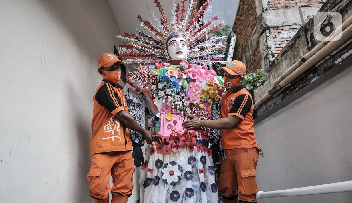 Petugas PPSU membawa ondel-ondel dari limbah plastik di Kantor Kelurahan Kemayoran, Jakarta, Senin (3/8/2020). Limbah plastik dikumpulkan dari wilayah setempat. (merdeka.com/Iqbal S. Nugroho)