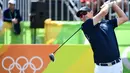 Pegolf Inggris, Justin Rose berkompetisi pada nomor perseorangan putra cabang golf di Olimpiade 2016, Rio de Janeiro, Kamis (11/8). Rose membuat kejutan dengan mencetak hole-in-one pertama sepanjang sejarah golf Olimpiade. (Emmanuel Dunand/AFP)