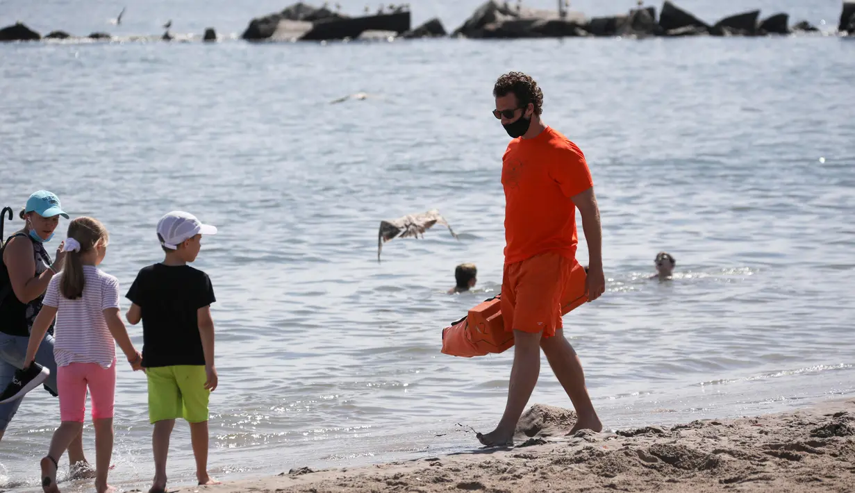 Seorang penjaga pantai berjalan di sebuah pantai di Coney Island, New York City, Amerika Serikat, pada 1 Juli 2020. Pada Rabu (1/7), delapan pantai di New York City secara resmi dibuka untuk berenang selama jam kerja harian penjaga pantai, yakni mulai pukul 10.00 hingga 18.00. (Xinhua/Wang Ying)