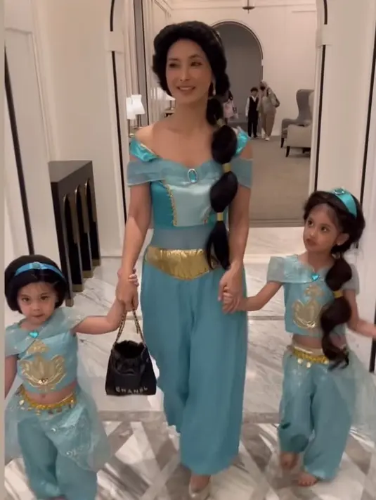 Eva Anindita bersama kedua putrinya tampil totalitas dengan busana ala Princess Jasmine warna biru. Bahkan lengkap dengan model rambut ikat belakang sampingnya. [@eva_anindita_zachrie]