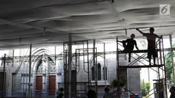Pekerja menyelesaikan pembuatan tenda dan dekorasi Natal di Gereja Katedral, Jakarta, Kamis (20/12). Gereja Katedral menyambut perayaan Misa Natal dengan mendirikan tenda. (Liputan6.com/Immanuel Antonius)