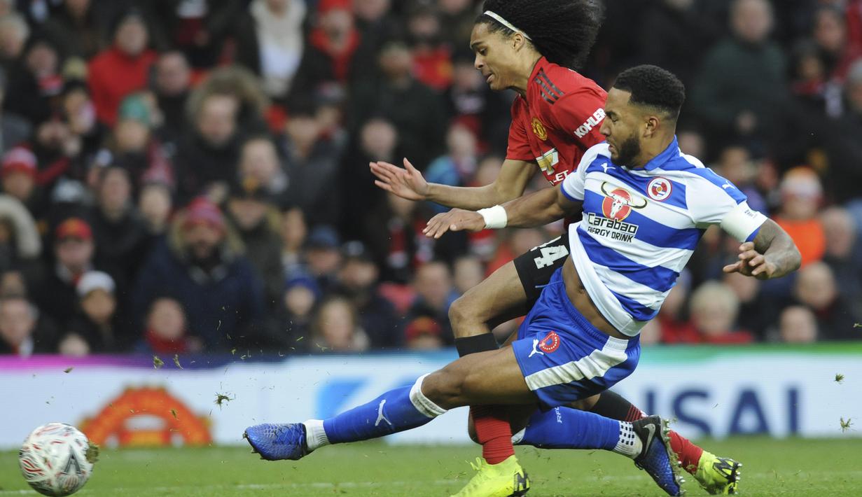 Pemain Manchester United, Tahiht Chong, berebut  bola dengan pemain Reading, Liam Moore, pada laga Piala FA di Stadion Old Trafford, Sabtu (5/1). Manchester United menang 2-0 atas Reading. (AP/Rui Vieira)