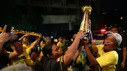 Suporter Mitra Kukar merayakan gelar juara dengan trofi Piala Jenderal Sudirman di Hotel Sultan, Jakarta, Minggu (24/1/2016). (Bola.com/Arief Bagus)