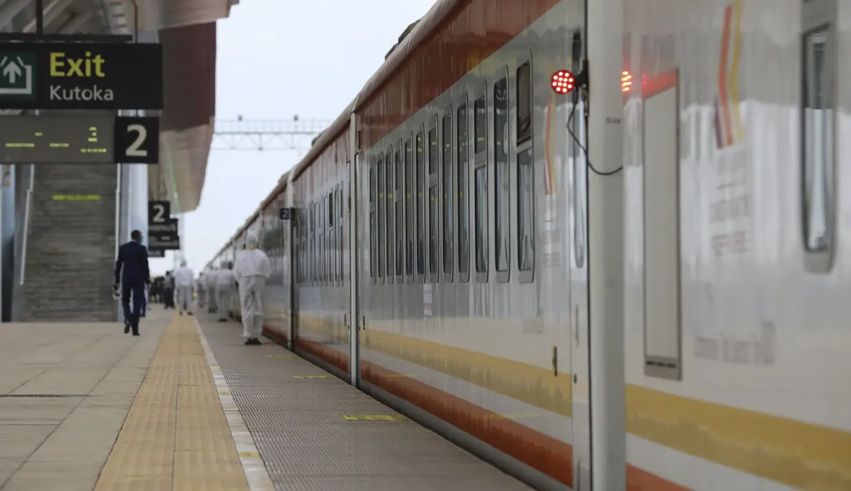 Para staf bersiaga saat penumpang menaiki kereta di Stasiun Nairobi di Nairobi, Kenya (13/7/2020). Jalur Kereta Rel Standar (Standard Gauge Railway/SGR) Mombasa-Nairobi pada Senin (13/7) kembali membuka layanan penumpang di tengah peningkatan langkah-langkah pencegahan COVID-19. (Xinhua/Feng Dong)