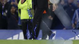 Antonio Conte  berjalan serta menatap pita biru yang berjatuhan saat perayaan kemenangan lusai melawan Watford pada laga Premier League di Stamford Bridge stadium, London, (15/5/2017). Chelsea menang 4-3. (AP/Tim Ireland)