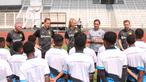 Direktur Papua Football Academy, Wofgang Pikal (kedua kanan) ditemani tiga legenda Borussia Dortmund, Paul Lambert (kiri), Joerg Heinrich (kedua kiri), dan Marcel Schmelzer (kanan) memberikan sambutan kepada peserta coaching clinic yang berlangsung di Stadion Madya, Senayan, Jakarta, Jumat (08/09/2023). (Bola.com/Bagaskara Lazuardi)