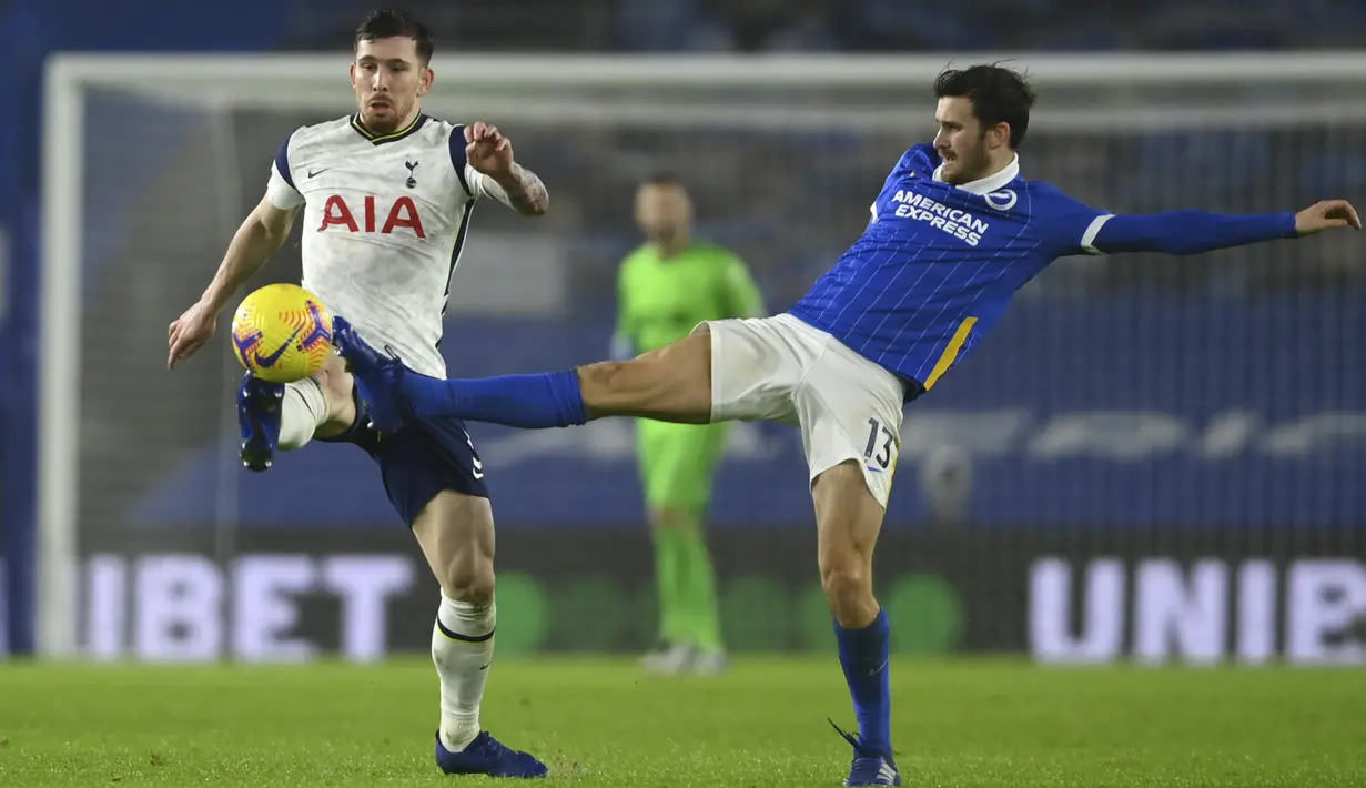 Gelandang Tottenham Hotspur,  Pierre-Emile Hojbjerg berebut bola dengan gelandang Brighton & Hove Albion, Pascal Gross dalam pekan ke-21 Liga Inggris di Amex Stadium pada Senin (1/2/2021) dini hari WIB. Brighton taklukkan Tottenham Hotspur dengan skor 1-0. (Mike Hewitt/Pool via AP)