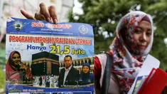 Korban penipuan menunjukan selebaran brosur program umroh PT SSI yang menampilakan wajah artis Peggy Melati Sukma, Jakarta, Minggu (20/3/2016). Peggy Melati akan dijadikan sebagai saksi kasus penipuan jamah Umroh. (Liputan6.com/Yoppy Renato)