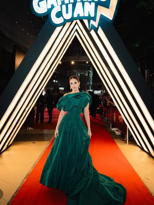 Gaun hijau model off shoulder dengan aksen mengembang di bagian pundak dan bawah, serta ramping di bagian perut di buat oleh desainer Yogie Pratama. [@anyageraldine]