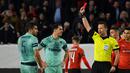Wasit Ivan Kruzliac mengeluarkan kartu merah untuk Sokratis pada leg 1, babak 16 besar Liga Europa yang berlangsung di Stadion Roazhon Park, Rennes, Jumat (8/3). Arsenal kalah 1-3 kontra Rennes. (AFP/Damien Meyer)