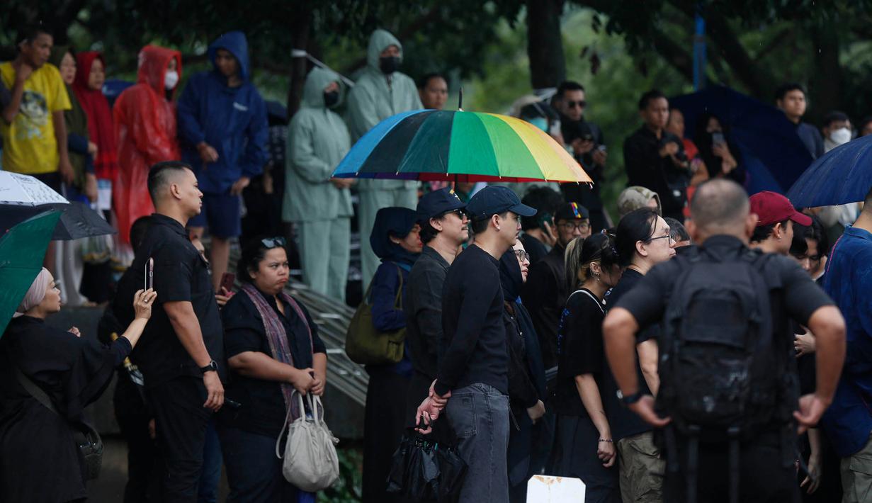 Suasana penuh duka disertai gerimis air hujan mengiringi pemakaman Oxavia Aldiano atau lebih dikenal dengan nama Vidi Aldiano di Tempat Pemakaman Umum (TPU) Tanah Kusir, Jakarta. Tampak dalam foto, musisi, presenter, sekaligus comedian, Vincent Ryan Rompies (tengah) saat menyaksikan prosesi pemakaman Oxavia Aldiano atau lebih dikenal dengan nama Vidi Aldiano di Tempat Pemakaman Umum (TPU) Tanah Kusir, Jakarta, Minggu (8/3/2026). (Kapanlagi.com/Budy Santoso)