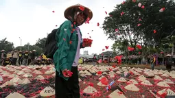 Warga Batang, Jawa Tengah melakukan tabur bunga saat menggelar aksi di depan Istana Merdeka, Jakarta, Rabu (3/6/2015). Dalam aksinya mereka menuntut Presiden Jokowi menghentikan rencana pembangunan PLTU batubara di Batang. (Liputan6.com/Faizal Fanani)
