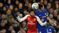 Pemain Arsenal, Mohamed Elneny melompat untuk merebut bola dari pemain Chelsea, Cesar Azpilicueta pada laga semifinal pertama Piala Liga Inggris di Stadion Stamford Bridge, Rabu (10/1). Chelsea harus puas diimbangi Arsenal 0-0. (AP/Kirsty Wigglesworth)