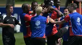 Pelatih Kanada AS Jesse Marsch (kiri) menyaksikan bek Kanada #15 Moise Lumpungu (tengah) diajak bercanda oleh rekan satu timnya selama sesi Latihan sehari sebelum semifinal Copa America 2024 di Basking Ridge, New Jersey, Senin (8/7/2024). (JUAN MABROMATA / AFP)