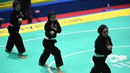 Tim pencak silat seni beregu putri Indonesia, Pramudita Yuristya (kiri), Lutfi Nurhasanah (tengah) dan Gina Tri Lestari (kanan) tampil dalam babak final Asian Games 2018 di TMII, Jakarta, Rabu (29/8). (ANTARA FOTO/INASGOC/Melvinas Priananda/nak/18)