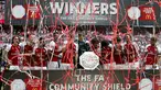 Pemain Arsenal memegang trofi usai mengalahakan Chelsea dalam pertandingan FA Community Shield di Stadion Wembley di London, Inggris (6/8). Arsenal berhasil menjadi juara usai mengalah Chelsea lewat adu pinalti 3-1. (AFP Photo/Ian Kington)