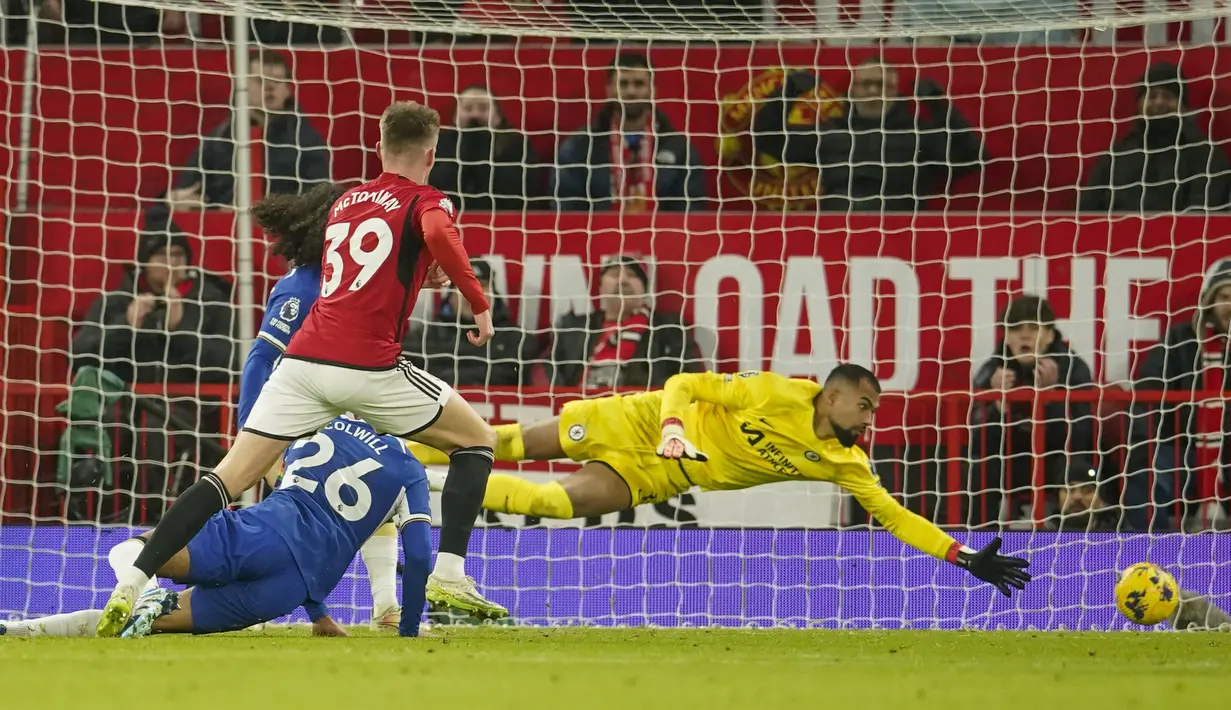 Kiper Chelsea, Robert Sanchez (kanan), tidak dapat menjangkau bola dari tendangan pemain Manchester United, Scott McTominay (kiri),  dalam pertandingan pekan ke-15 Liga Inggris 2023/2024 yang berlangsung di Old Trafford, Kamis (7/12/2023) dini hari WIB. (AP Photo/Dave Thompson)