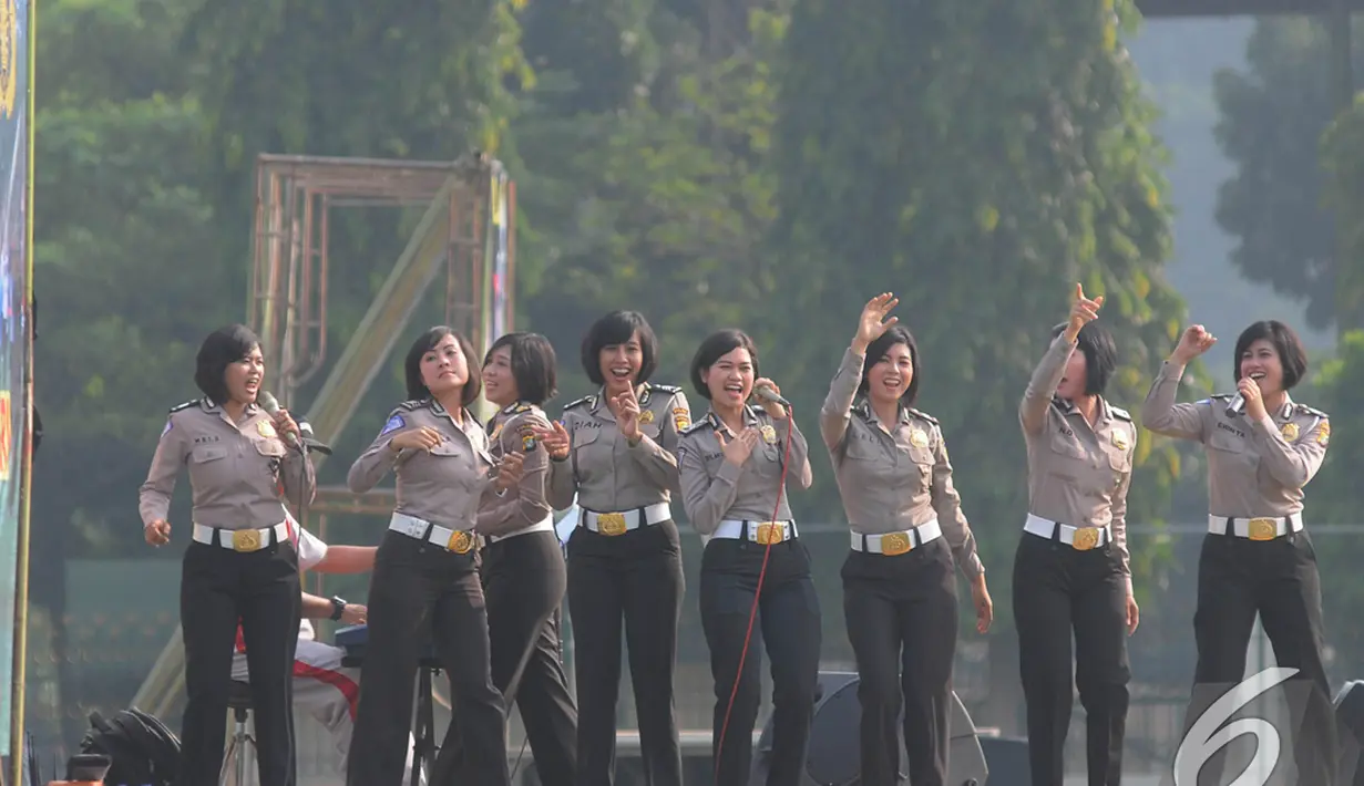 Para Polwan menyumbangkan suaranya untuk menghibur para peserta senam gabungan TNI dan Polri di Lapangan Utama Mako Kopassus, Cijantung, Jakarta, Jumat (21/11/2014). (Liputan6.com/Herman Zakharia)