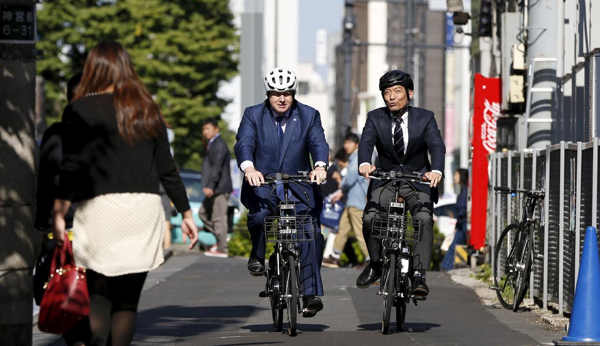 Walikota London Boris Johnson (kiri) bersepeda dengan Walikota Shibuya Ken Hasebe di Tokyo,  Rabu (14/10/2015).   Johnson mengajak pemerintah Tokyo berkerja sama untuk  mendorong Investasi, lapangan pekerjaan dan pertumbuhan ekonomi. (REUTERS/Issei Kato)