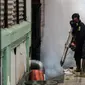 Petugas melakukan penyemprotan (fogging) untuk memutus siklus hidup nyamuk Demam Berdarah Dengue (DBD) di perumahan Jalan Delima Raya, Jakarta Barat, Senin (25/10/2021). Penyemprotan guna mencegah berkembangnya penyakit demam berdarah yang kerap muncul saat perubahan musim (Liputan6.com/Johan Tallo)