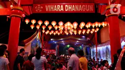 Warga keturunan Tionghoa menyaksikan atraksi barongsai dan liong pada malam Tahun Baru Imlek 2571 di Vihara Dhanagun, Bogor, Jumat (24/1/2020). Atraksi dilakukan  Grup Atraksi Seni Indonesia (GASI) untuk menghibur jemaah yang bersembahyang selama malam Imlek. (merdeka.com/magang/Muhammad Fayyadh)