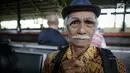 Seorang penumpang menunjukan pin garuda di Stasiun Gambir, Jakarta, Kamis (1/6). Dalam rangka memperingati HUT Pancasila PT KAI Daop 1 memberikan pin dan bendera merah putih kepada penumpang kereta api. (Liputan6.com/Faizal Fanani)