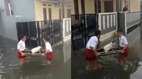 Saling Bahu-Membahu, Viral Dua Bocah Selamatkan Kucing Agar Tak Kena Banjir (Sumber: Twitter/kochengfs)