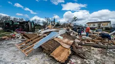 Warga dibantu relawan membersihkan puing-puing rumah mereka usai diterjang badai di Elon, Virginia (16/4). Badai disertai hujan lebat dan angin kencang melanda Virginia. (Jay Westcott/The News & Advance via AP)