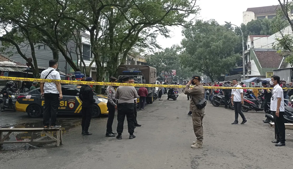 Petugas kepolisian berjaga di jalan menuju  insiden ledakan yang terjadi Polsek Astana Anyar, Bandung, Jawa Barat, Rabu (7/12/2022). Penyidik Detasmen Khusus (Densus) 88 antiteror Mabes Polri telah menuju ke lokasi terjadinya ledakan diduga akibat bom bunuh diri di Polsek Astana Anyar. (AP Photo/Ahmad Fauzan)