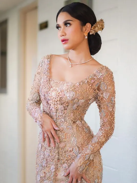 Ia menyanggul rambutnya dengan gaya semi-Bali. Ia memakai hiasan rambut seperti gadis Bali.  [@azizahsalsha_].