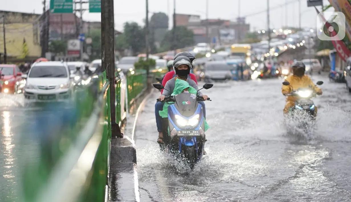 Pengendara motor menerobos banjir yang menggenangi Jalan Arif Rahman Hakim di Depok, Jawa Barat, Senin (18/5/2020). Sistem drainase buruk menjadi penyebab utama kawasan tersebut selalu tergenang banjir setiap hujan deras. (Liputan6.com/Immanuel Antonius)