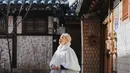Bunga Citra Lestari mengenakan hanbok warna ungu salur putih terlihat pada bagian rok yang mengembang. Hanbok pun dilengkapi luaran model crop putih dengan aksen bulu pada bagian leher dan bawah.  [@itsmebcl]