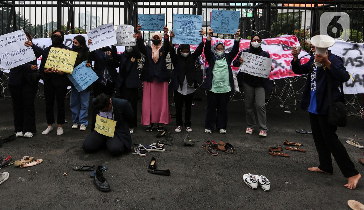 Mahasiswa melakukan aksi teatrikal sambil membawa poster tuntutan di depan Gedung DPR/MPR RI, Jakarta Pusat, Jumat (9/9/2022). Demo tersebut untuk menolak kebijakan pemerintah menaikkan harga BBM. (Liputan6.com/Johan Tallo)