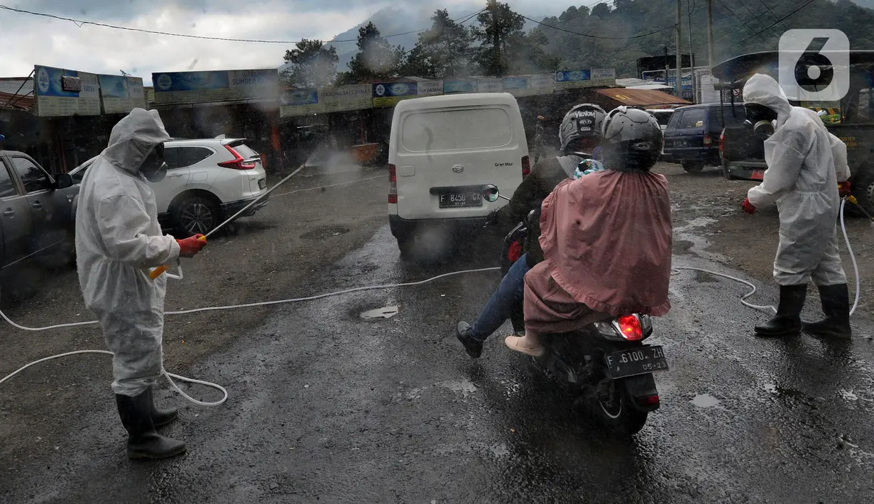 Anggota Batalyon B Brimob Cipanas melakukan penyemprotan disinfektan saat penyekatan arus lalu lintas di kawasan Ciloto, Cianjur, Jawa Barat, Jumat (17/4/2020). Penyemprotan yang dilakukan selama 20 hari tanpa henti ini untuk mencegah penyebaran virus corona COVID-19. (merdeka.com/Arie Basuki)
