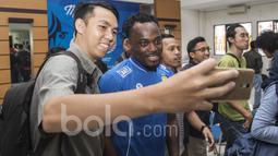 Bintang Persib Bandung, Michael Essien, melayani permintaan swafoto para wartawan. Meski baru tiba di Bandung dan langsung melakukan jumpa pers, mantan pemain Chelsea itu tetap ramah menyapa wartawan. (Bola.com/Vitalis Yogi Trisna)
