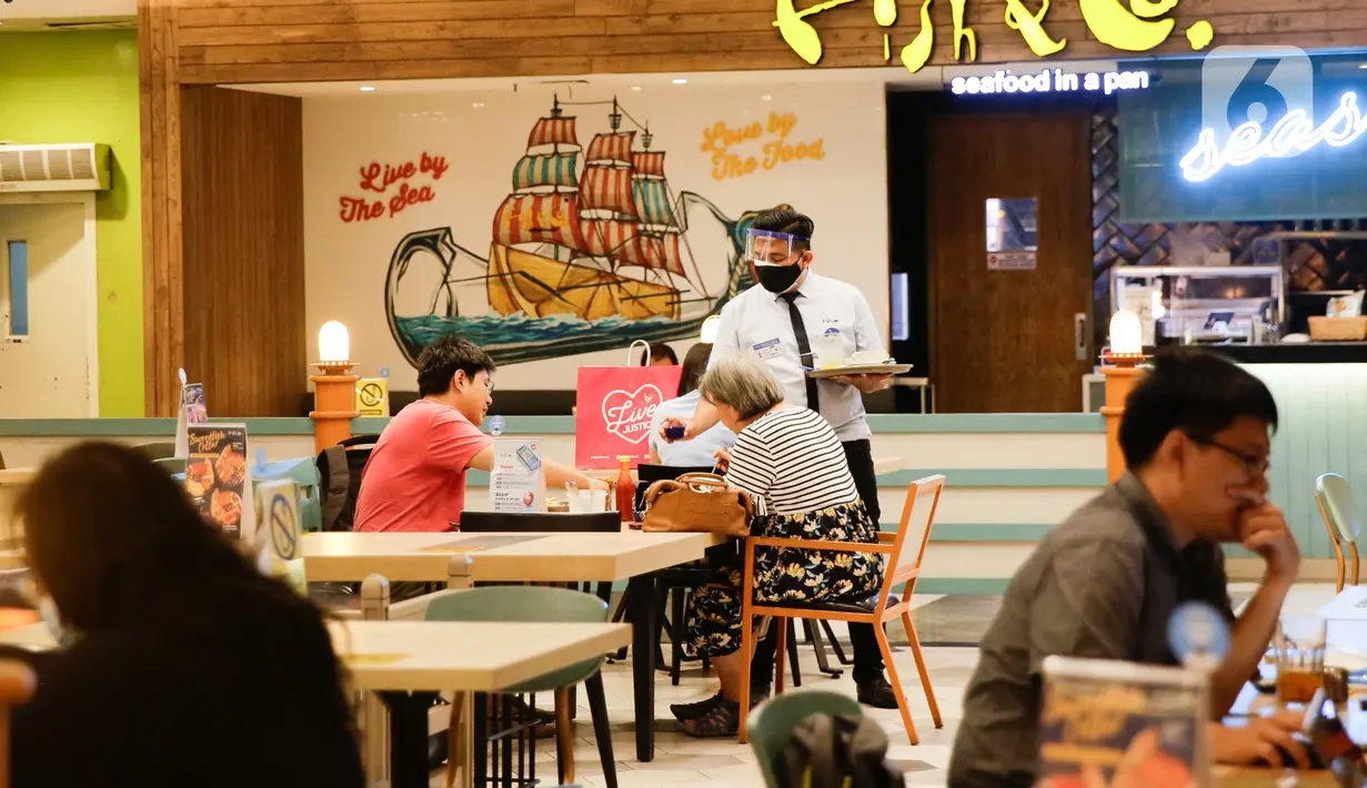 Karyawan melayani pengunjung di restoran yang berada di Mal Central Park, Jakarta, Jumat (20/8/2021). Restoran dalam pusat perbelanjaan kini bisa makan di tempat dengan syarat kapasitas maksimal 25 persen, satu meja maksimal dua orang, dan waktu makan maksimal 30 menit. (Liputan6.com/Angga Yuniar)