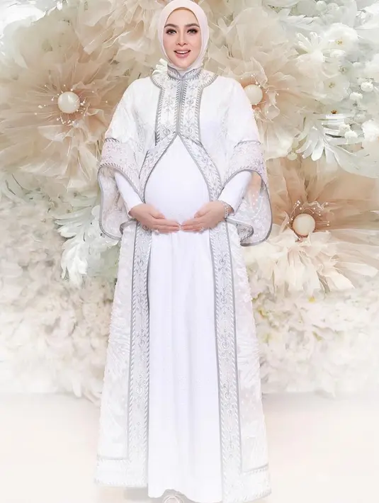 Menikah pada 2019 dengan Reino Barack, akhirnya Syahrini mengumumkan kehamilannya pada Mei 2024 yang telah ditunggu selama 5 tahun. Saat syukuran, Syahrini mengenakan busana serba putih dari outer, inner, dan kerudungnya. [@princessyahrini]