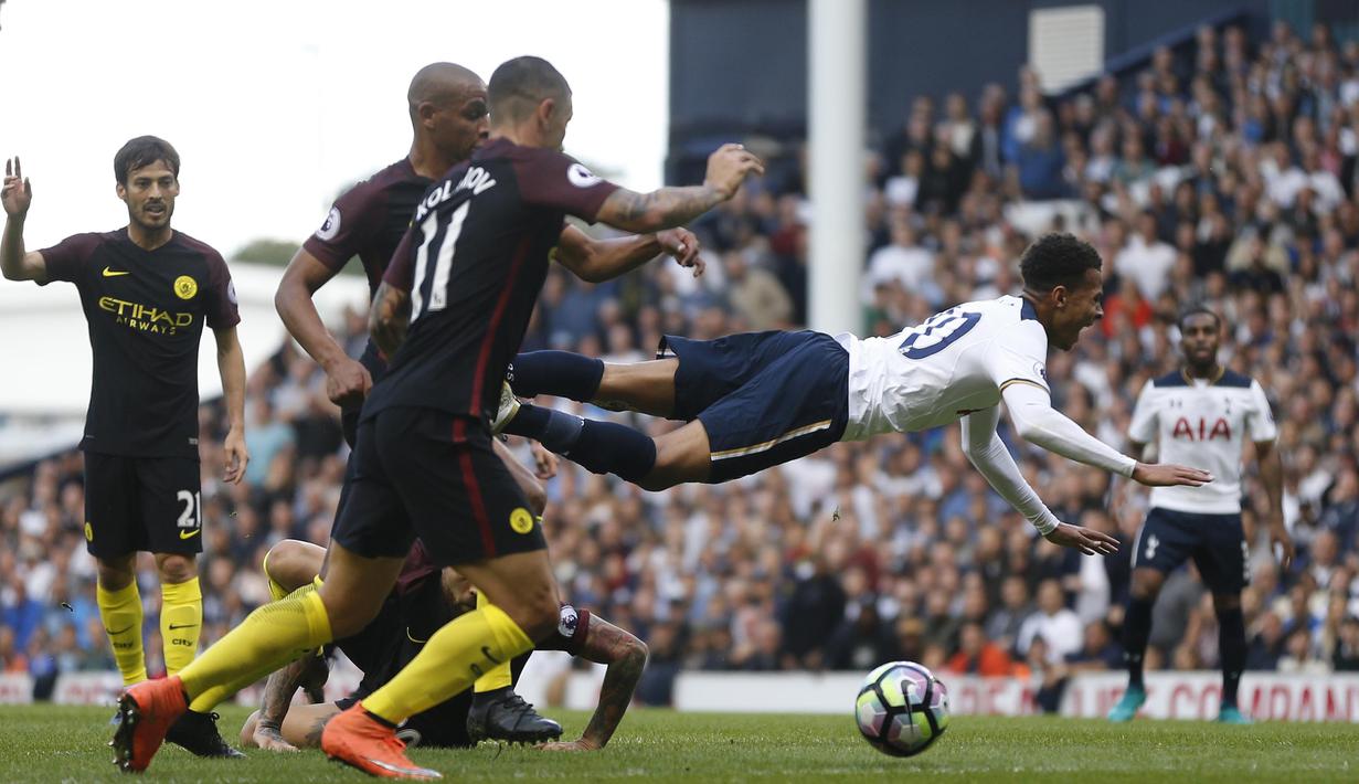 Pemain Tottenham Hotspur, Dale Alli terjatuh saat dihadang  para pemain Manchester City pada lanjutan Premier League di Stadion White Hart Lane, London, Minggu (2/10/2016). (AP/Frank Augstein)