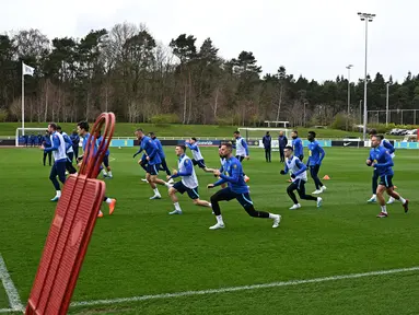 Para pemain Inggris melakukan pemanasan selama sesi latihan tim di St George's Park di Burton-on-Trent, Inggris tengah, pada 21 Maret 2023. (AFP/Paul Ellis)
