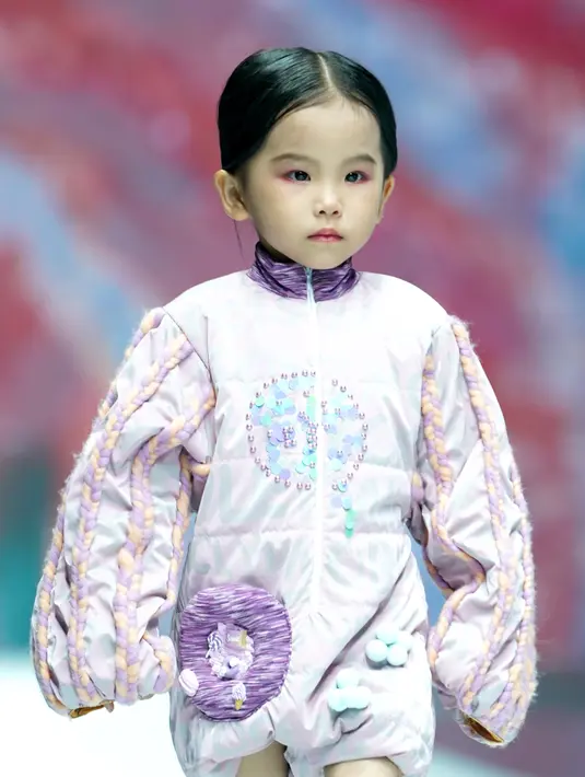 Model cilik menampilkan kreasi busana dalam sebuah peragaan busana di Hangzhou, China (24/8/2020). Peragaan busana tersebut diadakan sebagai bagian dari ajang China International Kids Fashion Week yang sedang berlangsung saat ini, menampilkan tren mode untuk pakaian anak-anak. (Xinhua/Chen Jianli)