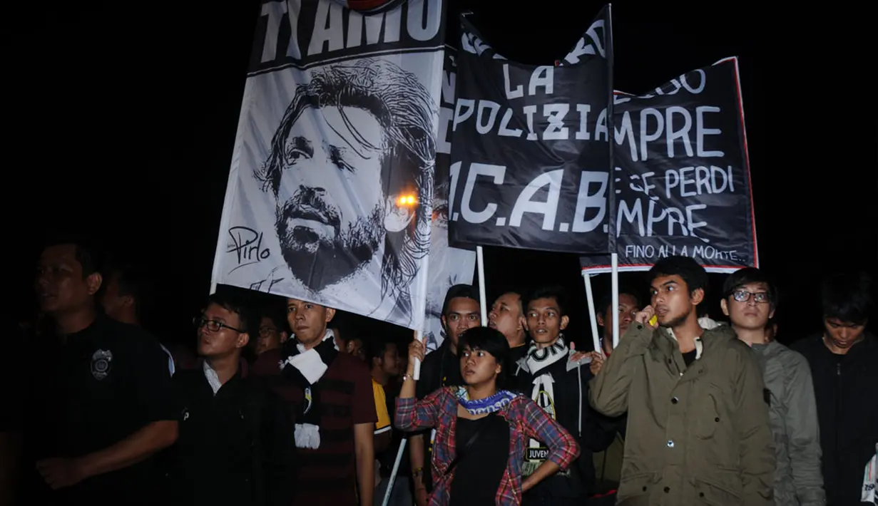 Hingga larut malam, suporter Juventus tetap setia menanti kedatangan tim kesayangan mereka tiba di Bandara Soekarno-Hatta, (4/8/2014). (Liputan6.com/Helmi Fithriansyah)