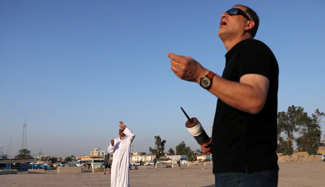 Pria Irak menerbangkan permainan tradisional layang-layang selama bulan Ramadan di sebuah lapangan di Kerbala pada 12 Mei 2019. Bermain layang-layang merupakan salah satu cara muslim Irak untuk mengisi waktu sambil menunggu saat berbuka puasa (ngabuburit). (REUTERS/Abdullah Dhiaa Al-Deen)