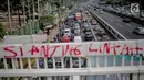 Pengendara melintasi dekat coret-coretan (vandalisme) di sekitar Gedung DPR/MPR RI, Jakarta, Selasa (24/9/2019). Demonstrasi mahasiswa dari berbagai kampus yang menolak pengesahan RUU Kitab Undang-Undang Hukum Pidana(KUHP) tercoreng oleh aksi vandalisme. (Liputan6.com/Faizal Fanani)