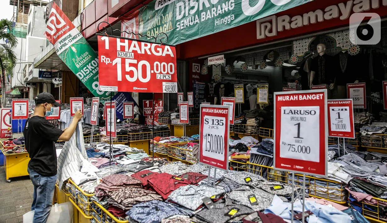 Pengunjung melihat pakaian yang dijajakan di salah satu tenant di Pasar Baru, Jakarta, Rabu (5/4/2021). Memasuki minggu terakhir bulan Ramadhan 2021, Pasar Baru tampak sepi pengunjung. (Liputan6.com/Faizal Fanani)