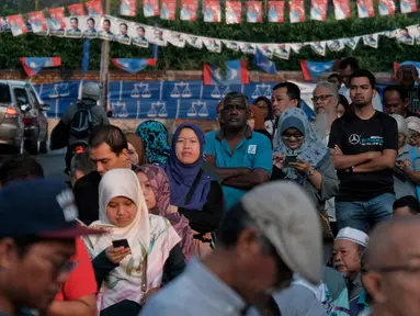 Warga Malaysia mengantre untuk menggunakan hak pilih mereka di tempat pemungutan suara (TPS) Kuala Lumpur, Rabu (9/5). Pemilihan umum Malaysia ini untuk menentukan Perdana Menteri. (AP Photo/Sadiq Asyraf)