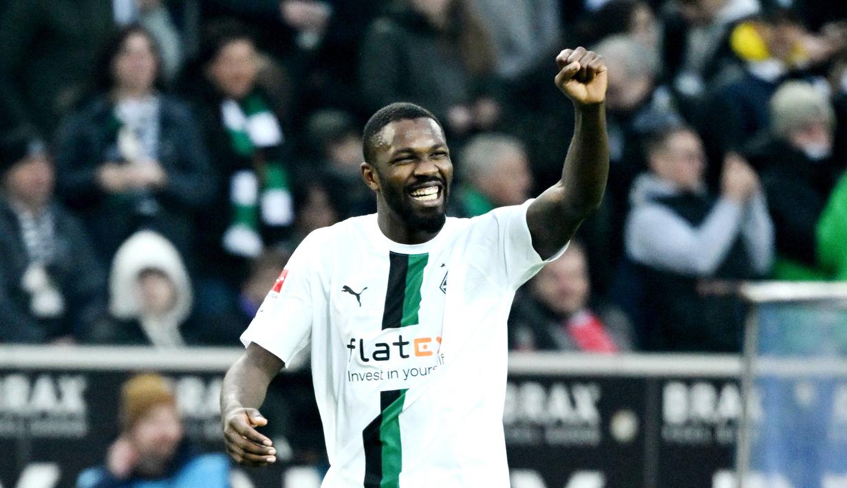 Pemain Borussia Moenchengladbach, Marcus Thuram, melakukan selebrasi saat melawan Bayern Munchen pada laga Liga Jerman (18/2/2023). Marcus Thuram tampil moncer bersama Borussia Monchengladbach dengan mengoleksi 16 gol dan lima assist musim ini. Mu bisa memboyong sang pemain ke Old Trafford lantaran kontraknya bersama Monchengladbach akan berakhir pada akhir Juni 2023. (AFP/Ina Fassebender)